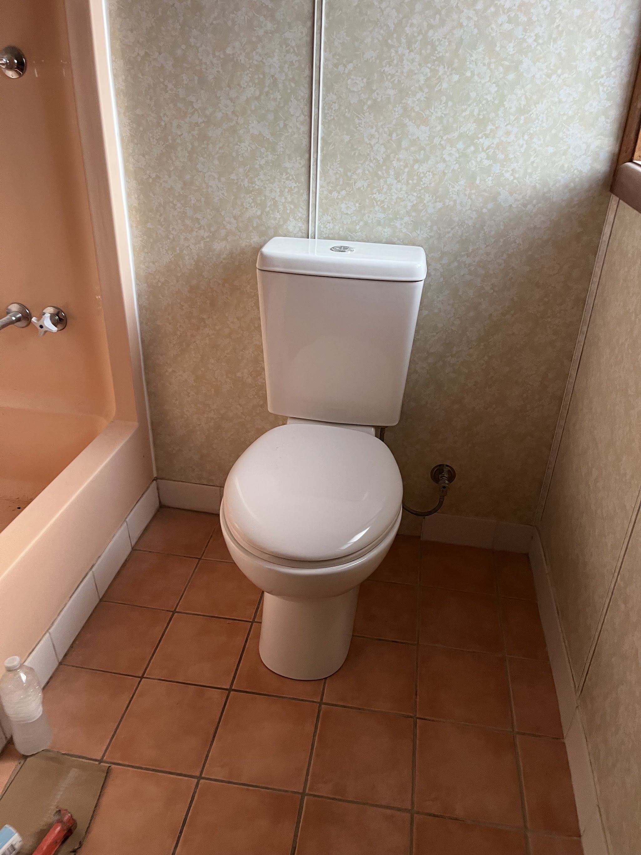 New toilet suite installed in a tiled bathroom
